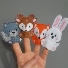 hand with five different animal finger puppets on it