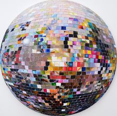 a large mirror ball with many different colored tiles on it