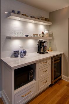 a kitchen with white cabinets and open shelves