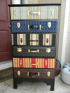 a stack of suitcases sitting on top of each other in front of a door