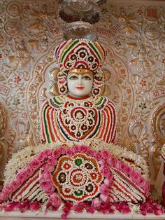 the statue is decorated with flowers and other decorations