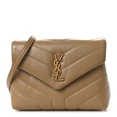 This is an authentic SAINT LAURENT Calfskin Y Quilted Monogram Toy Loulou Crossbody Bag in Dark Latte. This elegant shoulder bag is crafted of chic chevron quilted calfskin leather in beige. The bag features a leather shoulder strap and aged gold hardware. The front flap features a prominent gold YSL monogram detail and opens to a partitioned black fabric interior with zipper and patch pockets. Bag Dark, Chevron Quilt, Black Fabric, Gold Hardware, Patch Pocket, Calf Skin, Saint Laurent, Crossbody Bag, Shoulder Strap