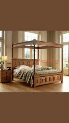 a bed with four drawers and a canopy over it in front of two large windows