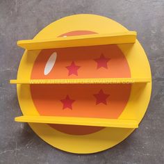 a yellow plate with red stars on the bottom and two shelves above it that are attached to each other