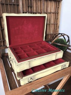 an open suitcase sitting on top of a wooden table