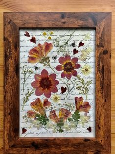 a wooden frame with some flowers on it