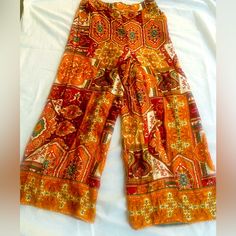 Vibrant Printed Rayon Pant By Haute Hippie High Waisted With Elastic Waist In Back, Generous Cut In Leg Front Rise: 14" Back Rise: 15 1/2" Hip: 17" (Flat) Length: 39 1/2" Hidden Pockets 100% Rayon Orange Full-length Cotton Bottoms, Orange Full Length Cotton Bottoms, Orange Trousers With Elastic Waistband, Orange Cotton Wide-leg Pants, Stretch Orange Pants With Elastic Waistband, Bohemian Orange Cotton Bottoms, Orange Bohemian Cotton Bottoms, Orange Bohemian Wide-leg Pants, Bohemian Orange Wide-leg Pants