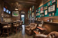 a bar with leather chairs and pictures on the wall