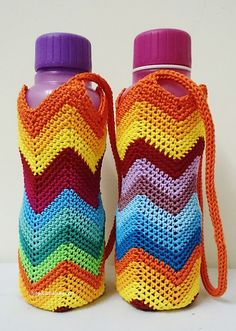 two water bottles with handles made out of crochet