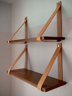 two wooden shelves are hanging on the wall