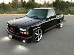 a black pickup truck parked in a parking lot