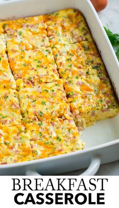 breakfast casserole with ham and cheese in a white baking dish