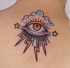 an all seeing eye tattoo on the back of a woman's neck