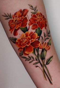 an orange flower tattoo on the arm