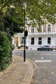 an empty street in front of a white building