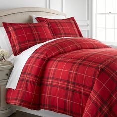 a red and white plaid comforter set on a bed