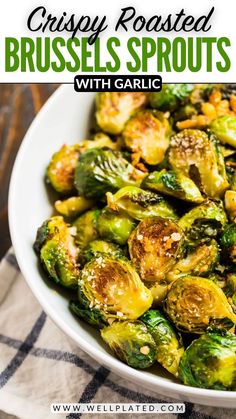 crispy roasted brussel sprouts with garlic in a white bowl