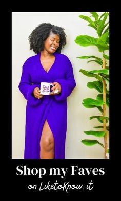 a woman in a purple dress holding a coffee mug