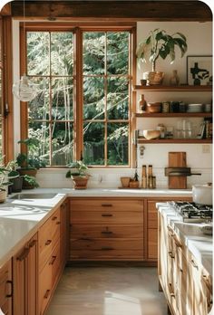 a kitchen filled with lots of wooden cabinets and counter top space next to a window