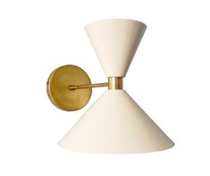 a white and gold wall light with a cone shaped shade on the back of it