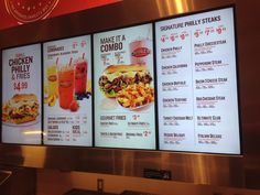 the menus are on display in front of the restaurant's large digital screen