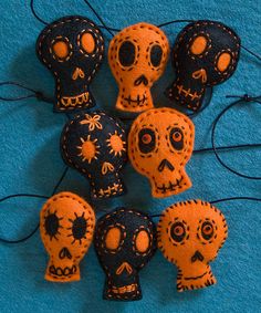 several orange and black sugar skulls on a blue background