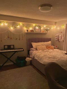 a bed room with a neatly made bed and string lights