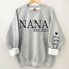 a gray sweatshirt with the name nanna est 2012 printed on it and two white bows