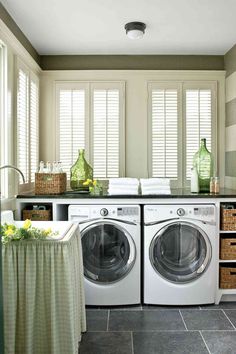 a washer and dryer sitting in a room next to each other on top of a tiled floor