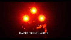 a red light with the words happy meat farms on it in front of black background