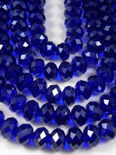 blue glass faceted beads on a white background