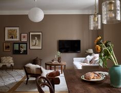 a living room filled with furniture and a wooden table topped with a plate of food