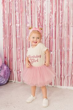 This organic T-shirt and mauve-pink tutu are perfect for your toddler's birthday girl outfit! This T-shirt and tutu set is perfect for all year and all themes. The best part is that this shade of pink is so versatile and goes with everything all year long!  This full tutu has ten layers with a wide elastic band inside to keep the itchy tulle off your little ones' skin. The multiple soft layers give a fluffy look but lays perfectly. The bow can clip onto the tutu for your desired look.  OPTIONS A Cute Pink Short Sleeve Tutu Dress, Pink Short Sleeve Tutu Dress, Cute Pink Party T-shirt, Spring Birthday Tutu Dress With Short Sleeves, Cute Short Sleeve Tutu Dress For Birthday, Cute Short Sleeve Birthday Tutu Dress, Short Sleeve Tutu Dress For Spring Birthday, Spring Short Sleeve Tutu Dress For Birthday, Pink Short Sleeve Tutu Dress For Birthday