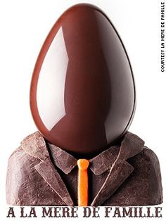 a chocolate egg with an orange carrot sticking out of it