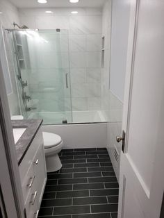 a bathroom with black and white tile flooring