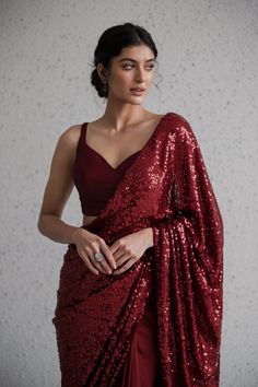 A Pakistani bride wearing a deep crimson red cocktail saree with an all-over sequin design. The saree is draped in a modern, sleek style and is paired with a matching red, fitted blouse. Cocktail Saree, Reception Bridal Dress, Red Cocktails, Fitted Blouse, Pakistani Wedding Dress, Red Cocktail, Cocktail Outfit, Sequin Design, Fitted Blouses