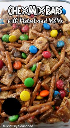 chex mix bars with pretzels and m & m's in a glass dish