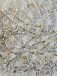 Sequin magic! Gorgeous white, gold and silver georgette fabric with mosaic sequin embroidered work all over. Please scroll through the pictures for sequin size. Perfect for skirts, jackets, shrugs, crop top, mask, blouse, the choices are endless!! Width 42in, Sequin area 36in This listing is for one yard, if bought in multiple quantities it comes as one continuous piece Please confirm your quantity before placing the order, no returns and no exchanges! Free shipping, delivery in 3-5 business day Glamorous Festive Embroidered Fabric With Sequins, Elegant White Embroidered Fabric With Sequins, Festive Gold Sequin Fabric, Elegant Festive Sequin Fabric With Contrast Sequin, Silver Embroidered Fabric With Sequins For Festive Occasions, White Embellished Embroidered Fabric For Festive Occasions, White Embellished Embroidered Fabric For Celebrations, Elegant Festive Sequin Fabric With Contrast, Festive Silver Sequined Embroidered Fabric