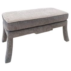 a grey bench with two legs sitting on top of it