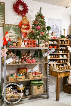 a christmas display in a store filled with lots of holiday decorations and gifts on shelves