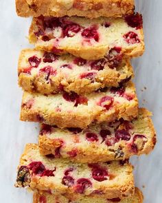 slices of strawberry bread stacked on top of each other with cranberry toppings