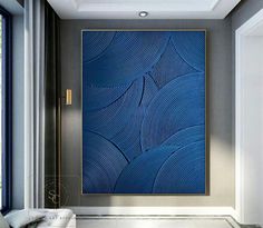 a large blue painting hanging on the side of a wall