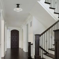 an empty hallway with stairs and railings leading up to the second floor in a home