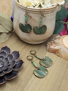 Wear a piece of botanical beauty with these amazing earrings! Antiqued brass ginkgo leaves with a touch of green verdigris will make a statement and delight your friends. Magnesite beads and brass accents will take them over the top and make them the star of any outfit. Antiqued brass verdigris leaf charms Magnesite elongated beads Brass accents Lever back ear closures Drop Length 2" Created in studio - Wilmington, NC Amazing Earrings, Ginkgo Leaves, Ginkgo Leaf, Botanical Beauty, Wilmington Nc, Brass Accents, Leaf Charms, Antique Earrings, Over The Top