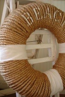 a rope wreath on top of a white chair