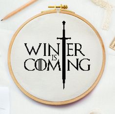 a cross - stitch pattern with the words winter is coming written in black on it