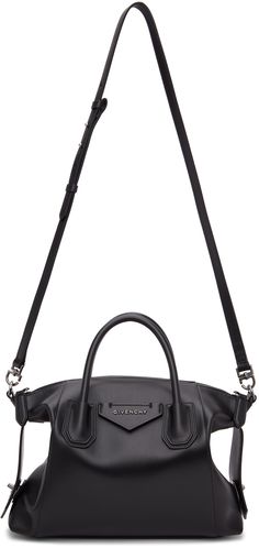 Buffed leather shoulder bag in black. Adjustable and detachable shoulder strap with tab-slot fastening. Twin rolled carry handles at top. Graphic leather appliqué with logo hardware at face. Strap with tab-slot fastening at sides for alternate styling. Leather bumper studs at base. Two-way zip closure. Patch pocket, card slot, and gold-tone logo stamped at interior. Canvas lining in beige. Silver-tone hardware. Approx. 12 length x 10.5 height x 3 width. Supplier color: Black | Givenchy Black Sma