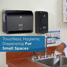 a man standing in front of a kitchen sink holding a napkin dispenser