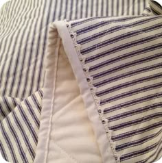 the fabric is stitched together with white and blue striped material on top of each other