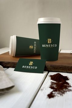 two coffee cups sitting on top of a wooden table